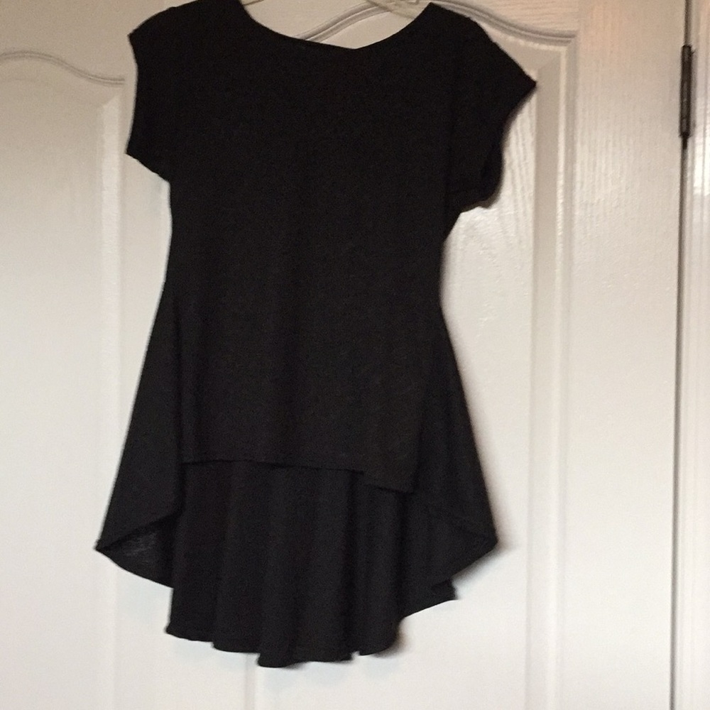 Blouse short in front and long in the back.